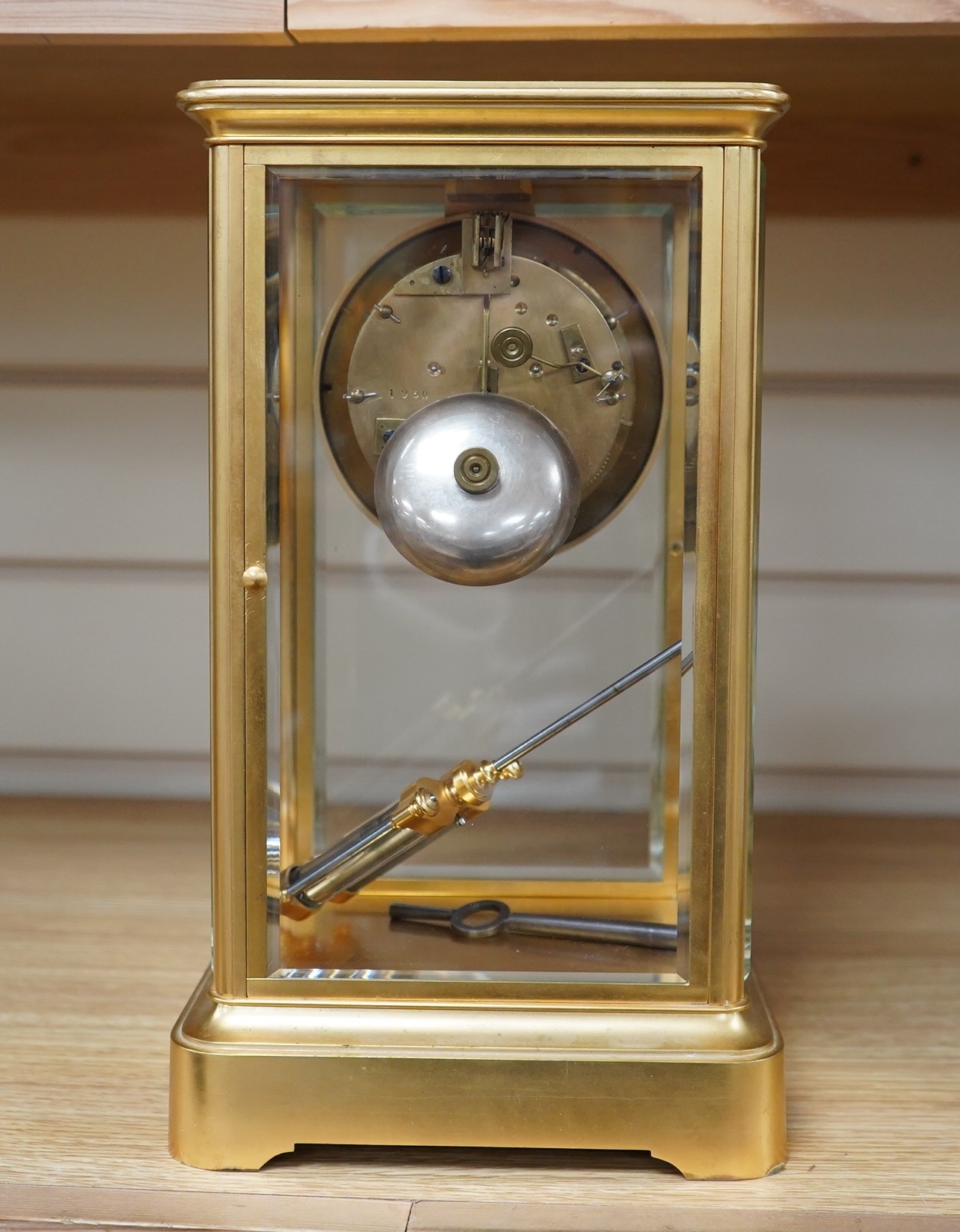 A late 19th century French gilt brass four glass clock, with visible Brocot escapement, key and pendulum, 29.5cm tall. Condition - fair, cracks to dial, not tested